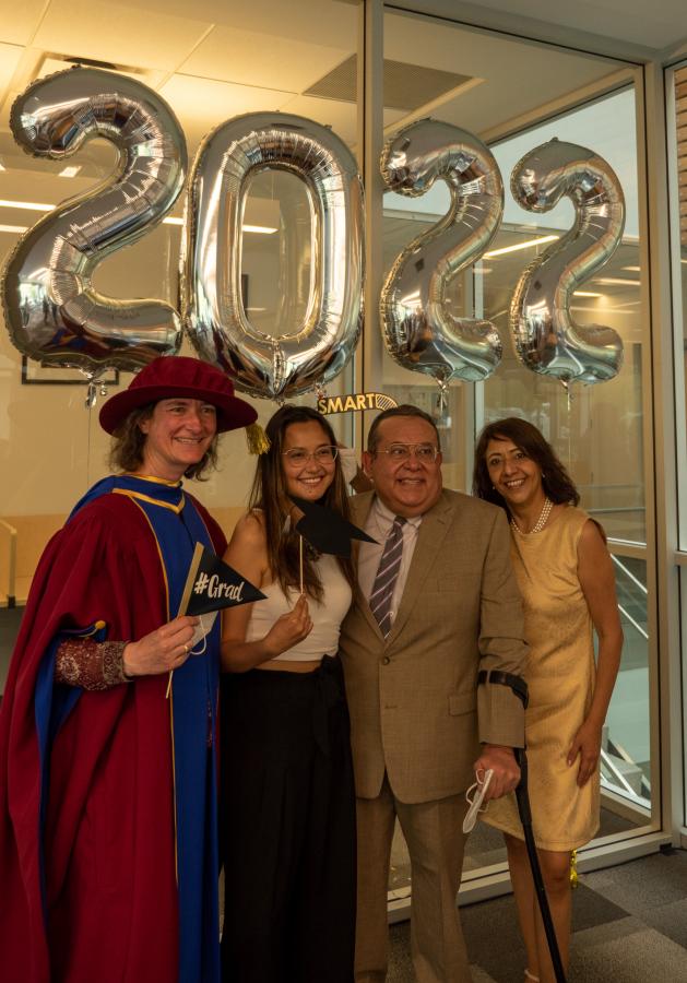 Principal Joanne Fox poses with graduating Vantage alumna and her family (photo: Kirc Cohen)