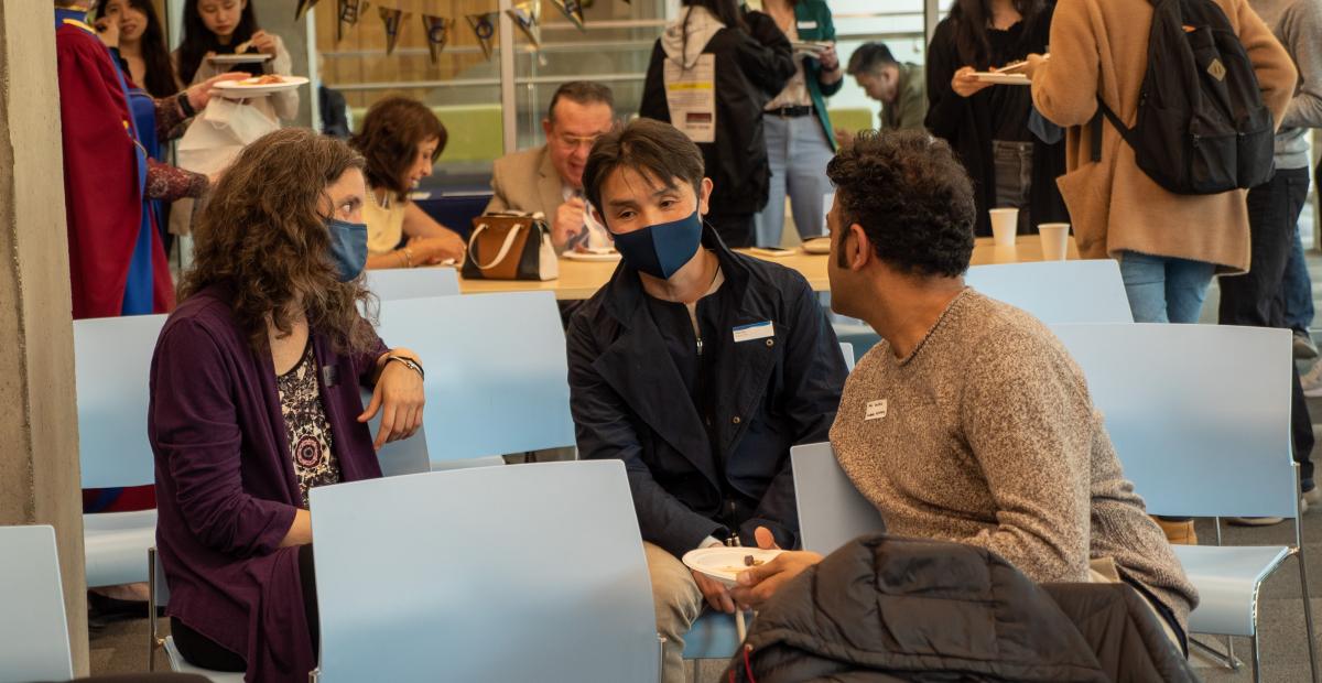 Professor Won Kim engages in conversation with other faculty members at the graduation ceremony (photo: Kirc Cohen)