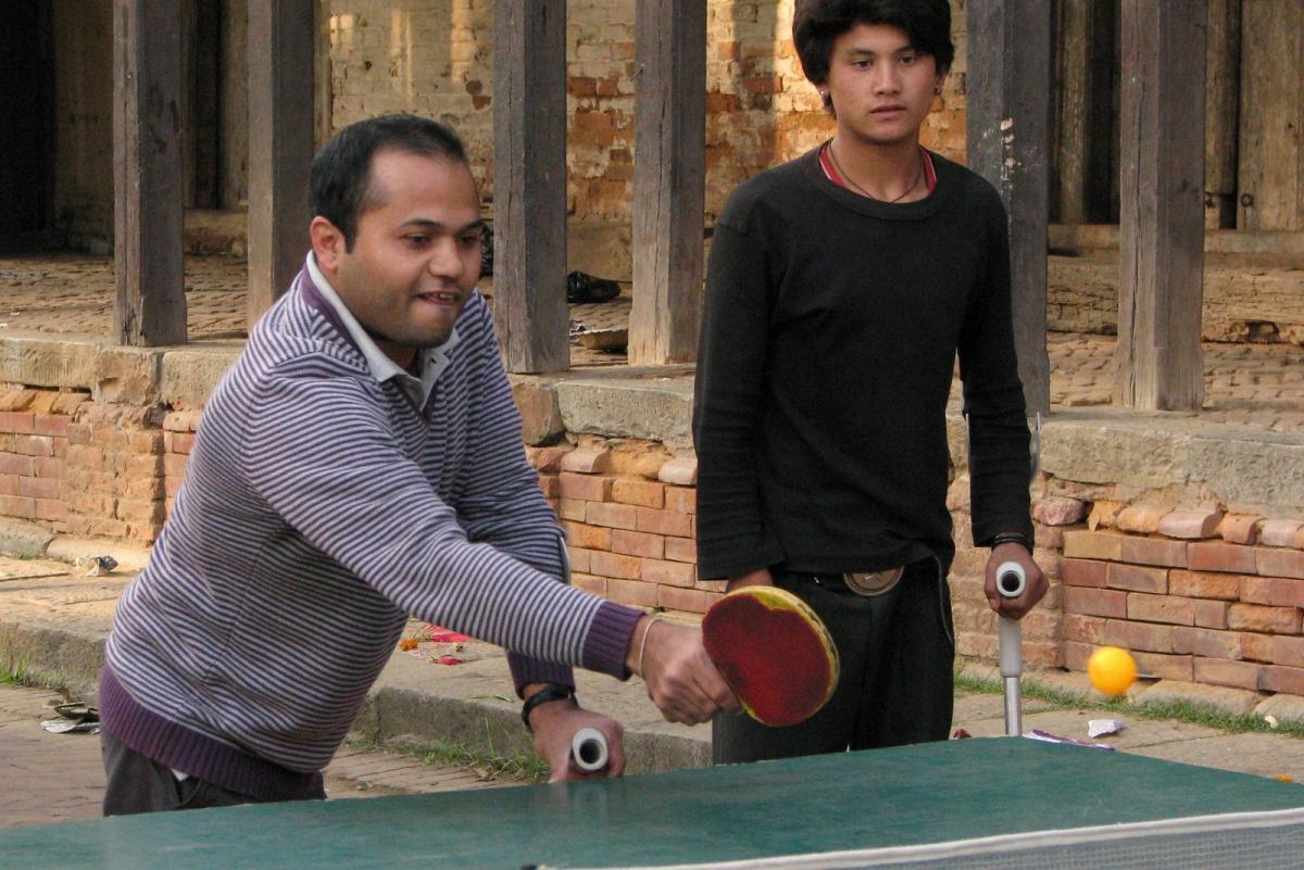 Dr. Raju surprises his ablebodied opponent in an informal game of table tennis in the inner courtyard of the Changu Narayan temple, considered to be Nepal's oldest