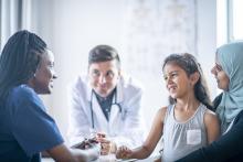 A mother and daughter having a consultation with two doctors (photo: FatCamera/iStock)